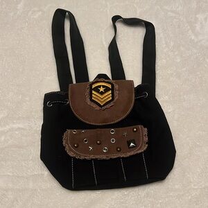 Black Backpack with Flap Closure and Emblem